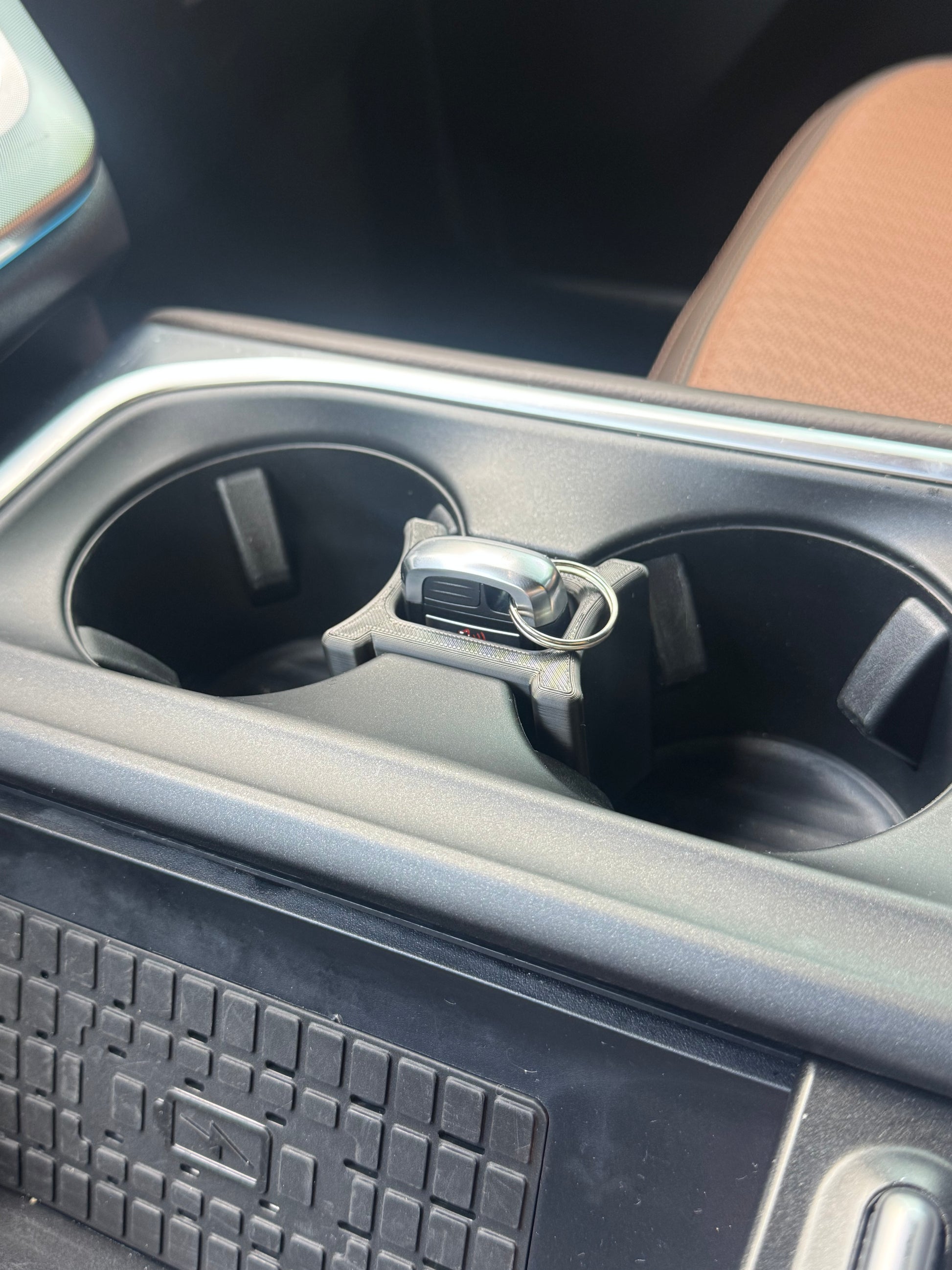 The Wedge cupholder insert installed in a 2025+ Ford Expedition center console, locking a key fob in its built-in item slot.